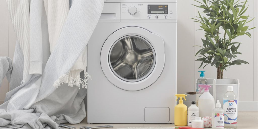A washing machine alongside various cleaning supplies in a well-organized room setting.