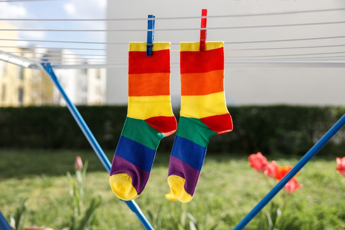  socks drying on a clothesline, socks ring and clips. 